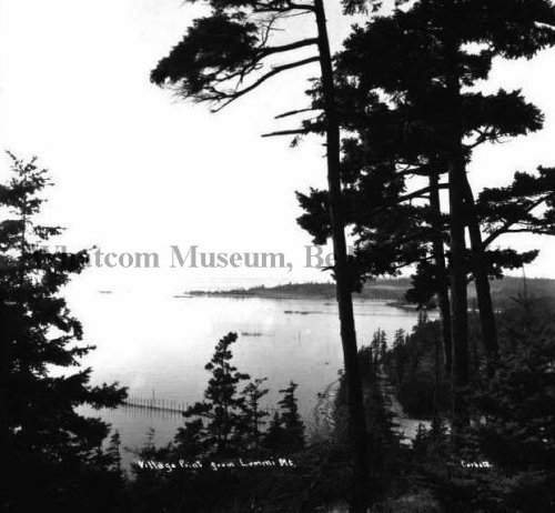 Village Point as Sen from Lummi Island.  Note the apparent row of fish-trap lead lines extending into the water. Source: whatcommmuseum.org